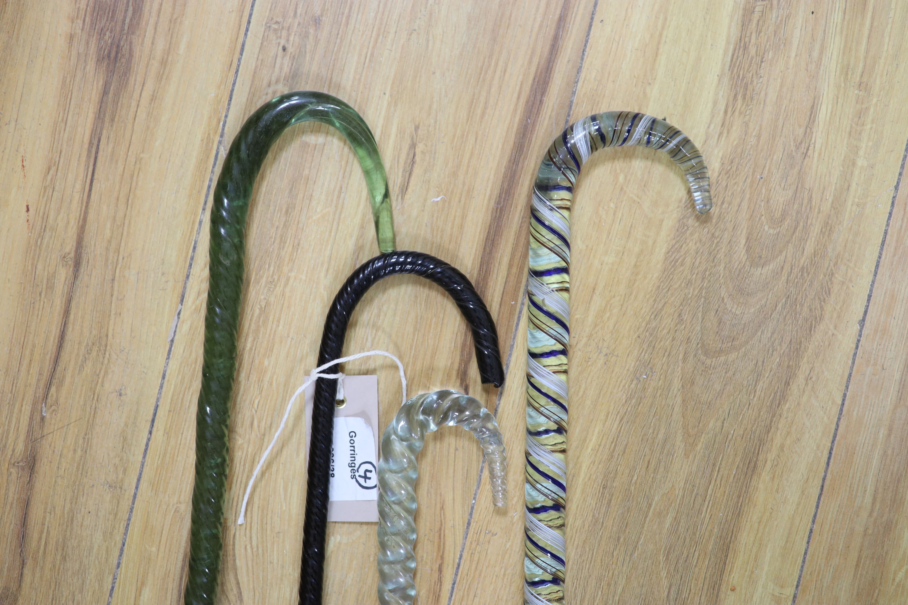 A 19th century Nailsea glass walking stick and three others (4)